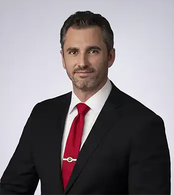 Michael Allmon portrait in a red tie and suit